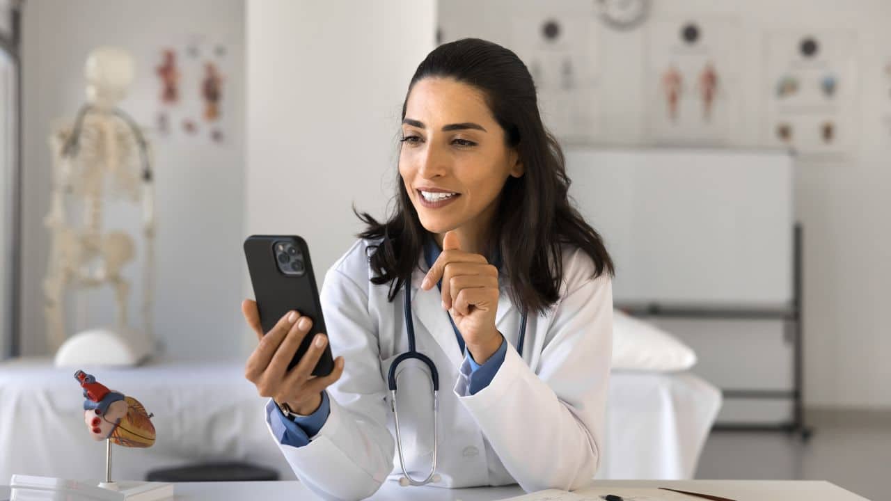 doctor use telehealth app on phone at workplace doctor use telehealth app on phone at workplace