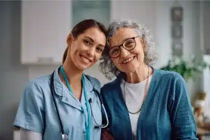 Happy senior woman and nurse during home visit Happy senior woman and nurse during home visit